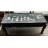 Oriental lacquered and painted coffee table, detailed with mother of pearl and soapstone figures