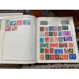 A Vintage Triumph stamp album containing a quantity of stamps