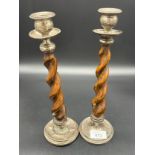 A Pair of silver and oak barley twist candle sticks [28cm high] [Repairs in areas]