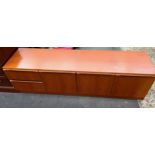 A Mid century low teak sideboard possibly by McIntosh of Kirkcaldy