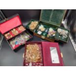 Three jewellery boxes, each containing a quantity of costume jewellery rings, bracelets and