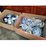 Two boxes of blue and white porcelain wares to include make Churchill and Willow pattern.