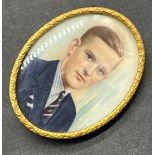 Antique gilt metal brooch fitted with a hand painted portrait of a well-dressed gentleman. [5.5x2.