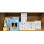 Shelf of Beatrix Potter musical figurines with boxes