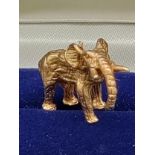 A 9ct yellow gold miniature elephant figure pendant. [Missing hoop] [7.82grams]