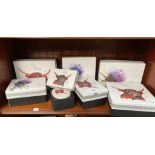 A Collection of boxed dishes by Tilnar Art depicting thistle and Highland Cows.