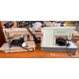 Two vintage Electric Singer sewing machines.