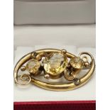 A Victorian gold brooch set with three large citrine stones. [Tested positive for 9ct gold] [7.