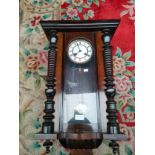 Antique Vienna wall clock with pendulum and key. In a working condition.