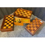Three antique folding chess boards together with chess pieces.