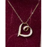 9ct yellow gold and diamond heart shaped pendant together with a 9ct yellow gold necklace. [1.