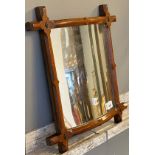 Antique bow shaped mirror [circus mirror] fitted within an arts and crafts frame.