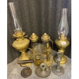 A collection of antique lanterns to include ornate brass paraffin lamp, pewter candle holder with