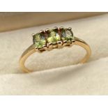 10ct yellow gold ladies ring set with three green emerald stones. [Ring size P] [1.83Grams]