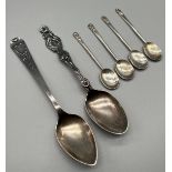 Two Sterling silver ornate tea spoons together with a set of four Edinburgh silver arts and crafts