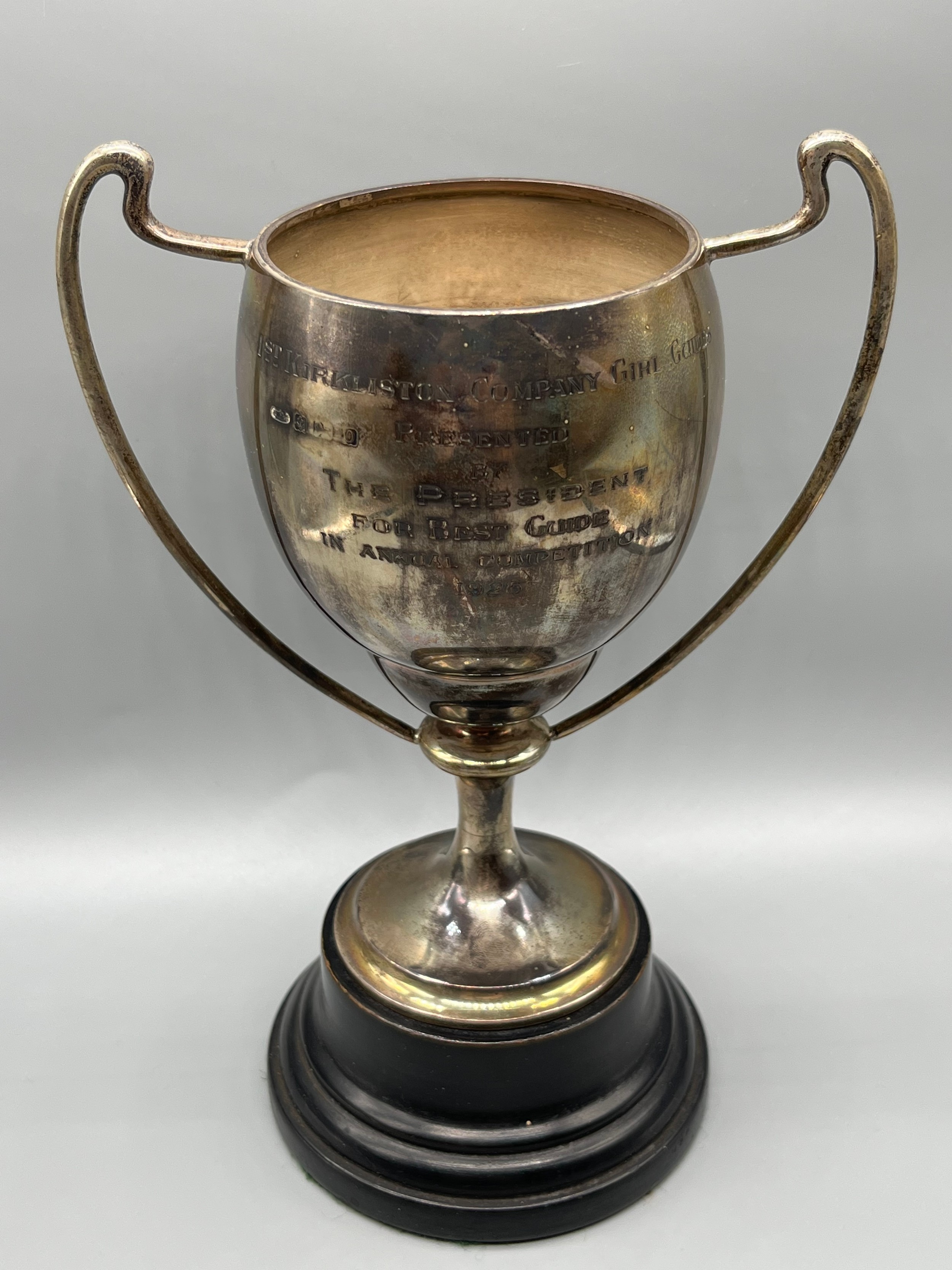 Birmingham silver two handle trophy with turned wooden stand. [Trophy stands 17cm high] [Weighs-