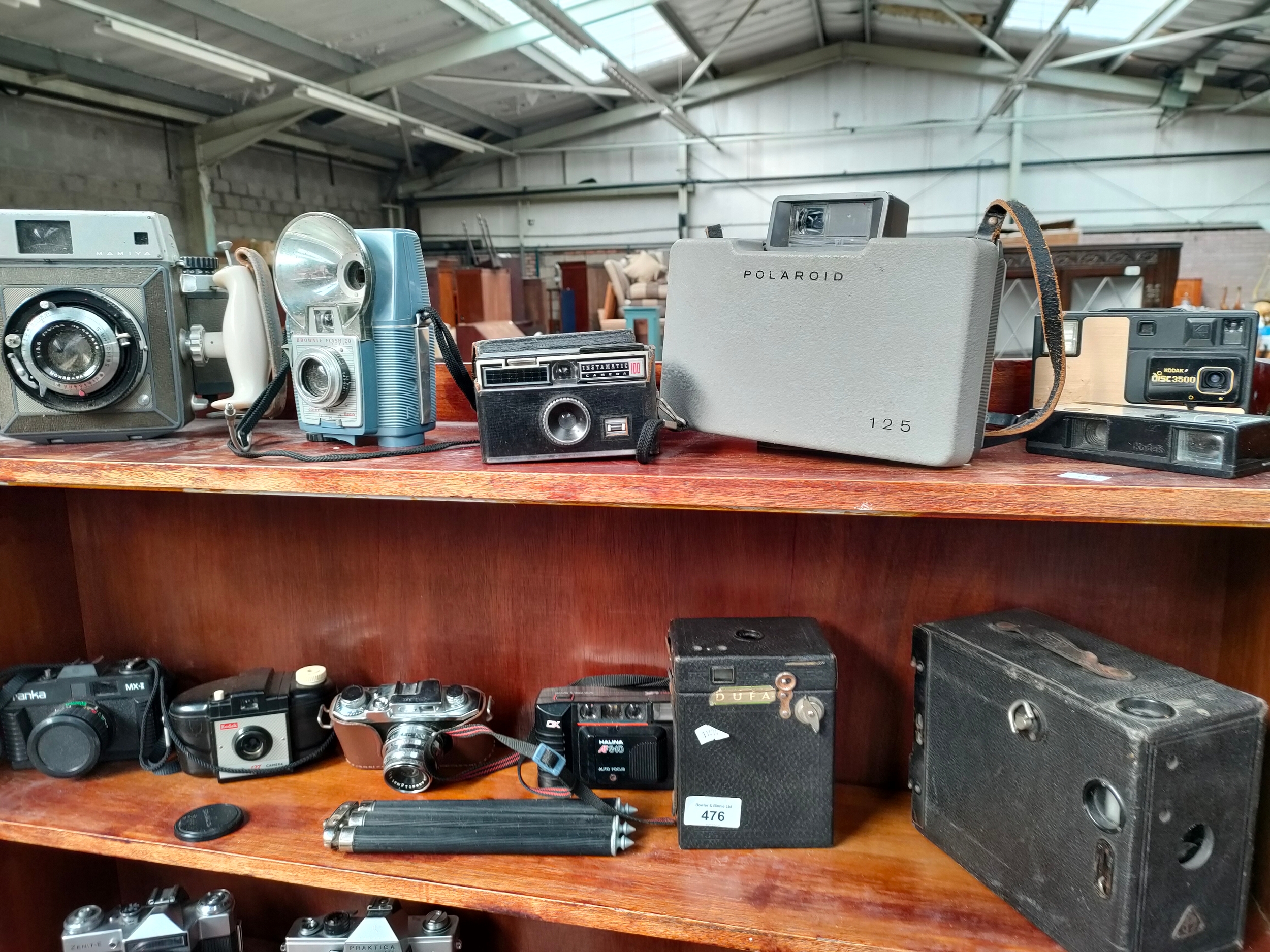2 Shelves of camera s includes Polaroid, Franca etc