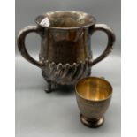 Edinburgh silver Hamilton and Inches three handle loving cup supported on three ornate feet.