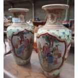 A pair of Oriental Satuma vases with panelling depicting Geisha's.