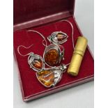 Silver necklace with silver and amber pendant, matching ring and earrings. Together with a vintage