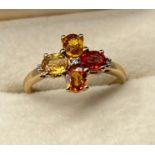 10ct yellow gold ladies ring set with four various gem stones with three diamonds. [Ring size P] [