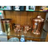 Shelf of antique copper ware includes drinks pourer etc