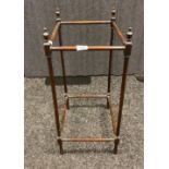 Antique mahogany stick stand, designed with four urn style finials. [67cm high]