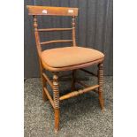 Antique chair, the back with turned stretchers, above a cushioned seat and raised on turned legs