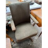 An antique office desk arm chair