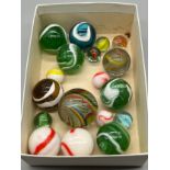 A Small box containing a selection of antique marbles to include two large German twist cane