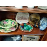 A shelf of collectables includes Scottish pottery Bowness & Dunes pottery etc