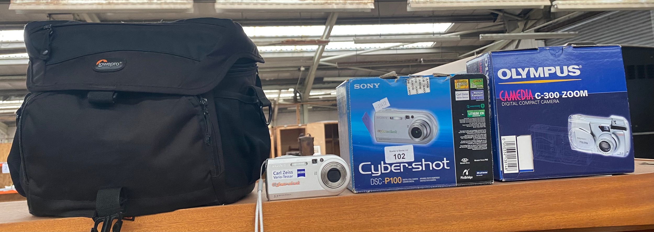 Boxed Sony cyber shot camera, boxed olympus camera, lower pro camera bag, etc
