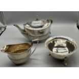 A London silver tea pot, Birmingham silver cream jug and London silver three foot sugar bowl