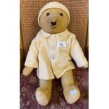 Antique mohair bear with glass eyes and movable joints, comes with a coat and matching hat.