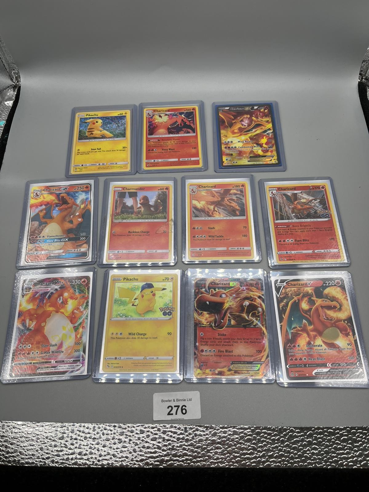 A Collection of protected Pokemon Charizard, Pikachu and Charmander