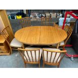 A Teak dining room table consisting of 6 chairs includes 2 carver's arm chairs