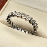 A White gold diamond full eternity band ring. [3.87grams] [Ring size N]