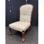 19th century rosewood framed high back bedroom chair upholstered in a floral material. Supported