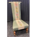 Antique prayer chair, the whole covered in a green upholstery with needlework strip, raised on