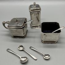 A Three piece Birmingham silver condiment set- two fitted with blue glass liners- comes with two