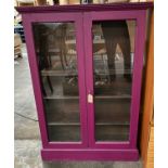 A vintage display cabinet painted purple