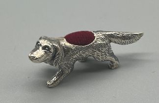 A Small Sterling silver dog pin cushion sculpture. [4cm in length]