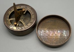 A Brass cased compass and sundial.