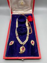Antique/ Vintage Indian gold pendant fitted with a large ruby stone off set by pearls and green