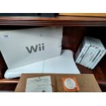 A shelf of Nintendo Wii console includes games and board