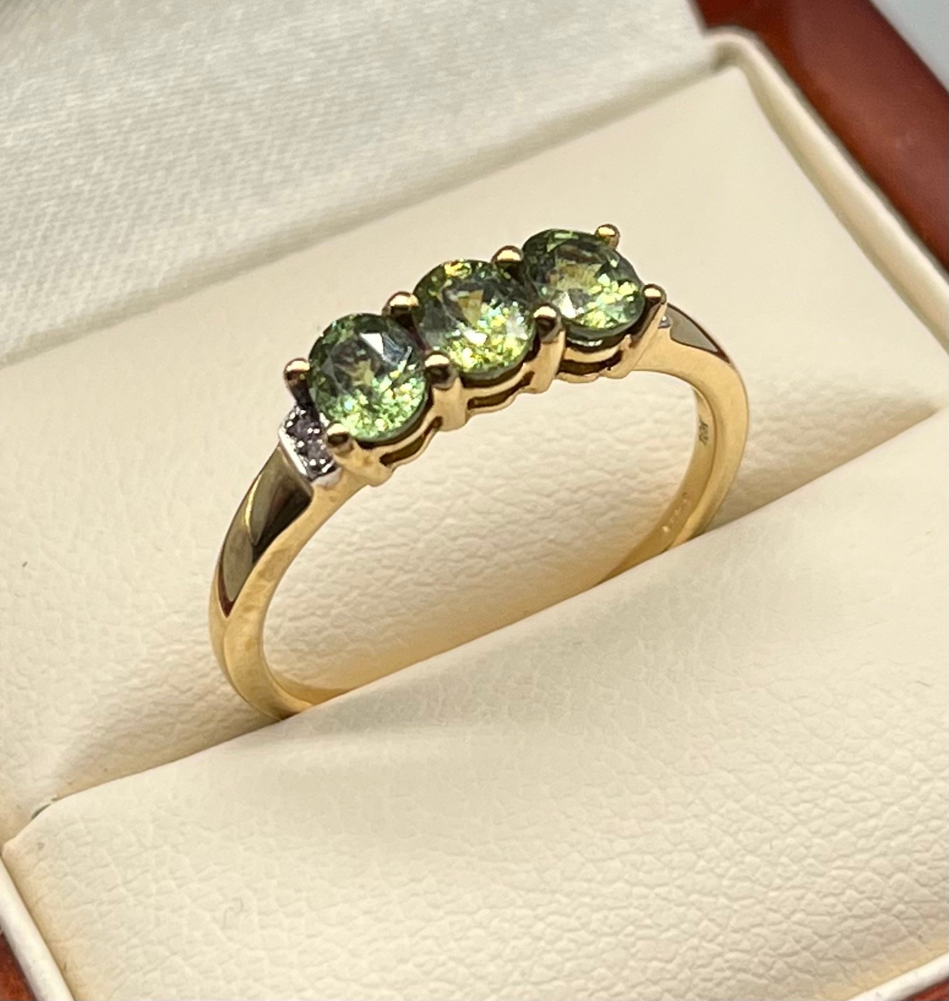 10ct yellow gold ladies ring set with three green stones off set by clear stone shoulders. [Ring - Image 2 of 2