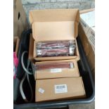 A box of suit case handles etc