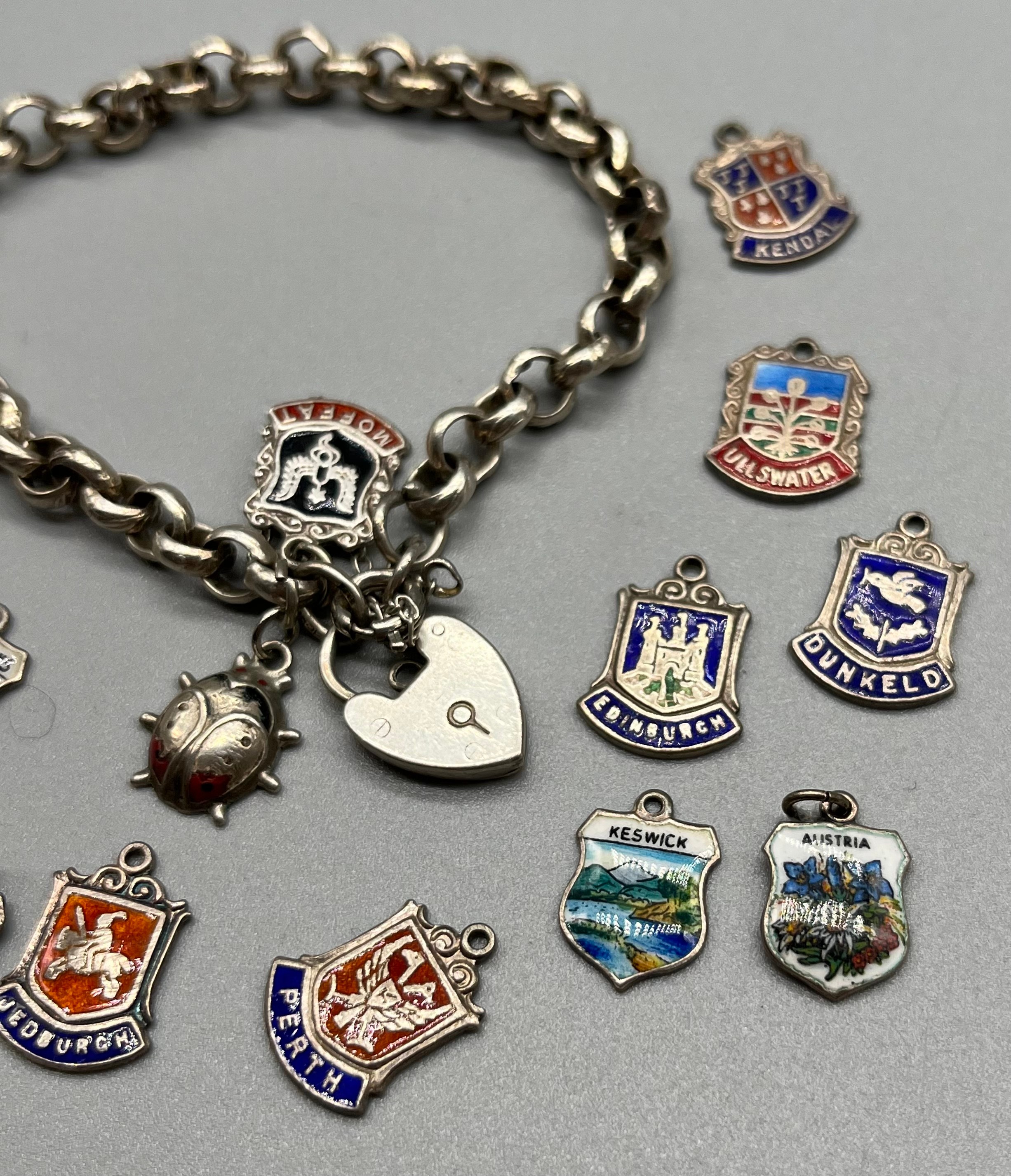 Silver charm bracelet together with silver and enamel souvenir shield fobs. - Image 2 of 3