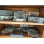 2 Shelves of war ship models with boxes some sealed