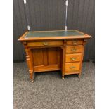 19th century Leather topped desk above a single drawer and knee hole section and flanked by four